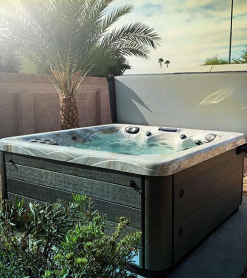Tropical-style backyard hot tub installation